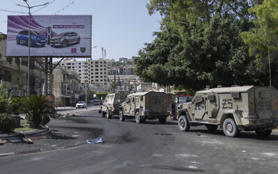Army vehicles are seen during an Israeli military raid on the militant stronghold of the Jenin refugee camp in the West Bank, July 4, 2023. (AP Photo/Nasser Nasser)