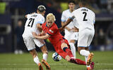 England's Anthony Gordon, center, fights for the ball with Israel's Stav Lemkin, left, and Israel's Karm Jaber during the Euro 2023 U-21 Championship semifinal soccer match at the Batumi Arena stadium in Batumi, Georgia, Wednesday, July 5, 2023.(AP/Tamuna Kulumbegashvili)