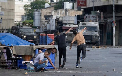 Palestinians clash with Israeli security forces during a military raid in the West Bank city of Nablus,, July 7, 2023. (AP Photo/Majdi Mohammed)