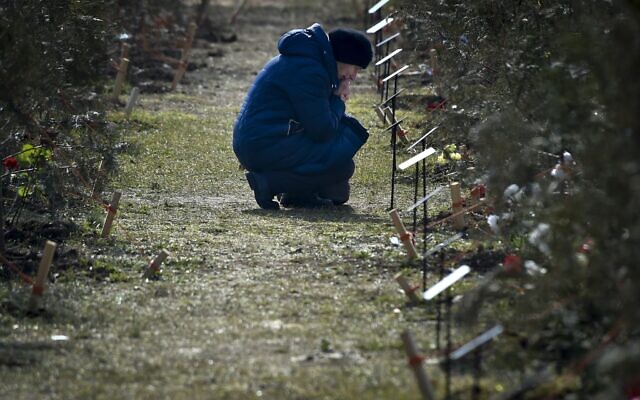 The mother of a Russian soldier who was killed in a military action in Ukraine kneels near a tree planted in memory of her son at the Alley of Heroes in Sevastopol, Crimea, February 25, 2023. (AP Photo) The mother of a Russian soldier who was killed in a military action in Ukraine kneels near a tree planted in memory of her son at the Alley of Heroes in Sevastopol, Crimea, February 25, 2023. (AP Photo)