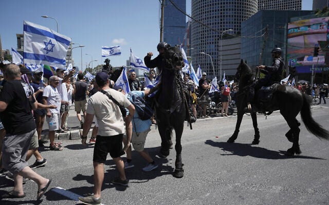 Israeli mounted police officers disperse demonstrators in Tel Aviv, July 11, 2023. (AP Photo/Oded Balilty)
