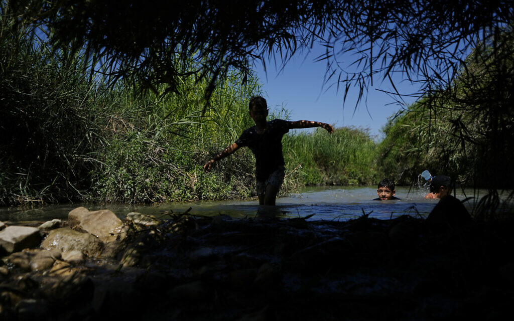 Children cool off in Ein Aviel springs near Aviel, Israel, Thursday, July 13, 2023. (AP/Ariel Schalit)