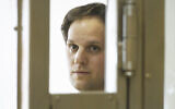 Wall Street Journal reporter Evan Gershkovich stands in a glass cage in a courtroom at the Moscow City Court in Moscow, Russia, June 22, 2023. (AP Photo/Dmitry Serebryakov, File)