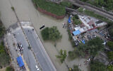 A road is inundated with water from the swollen river Yamuna in New Delhi, India, July 15, 2023. (AP Photo/Piyush Nagpal)