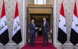 Syrian President Bashar Assad (right) welcomes Iraq's Prime Minister Mohammed Shia al-Sudani during a welcome ceremony in Damascus, Syria, July 16, 2023. (SANA via AP)