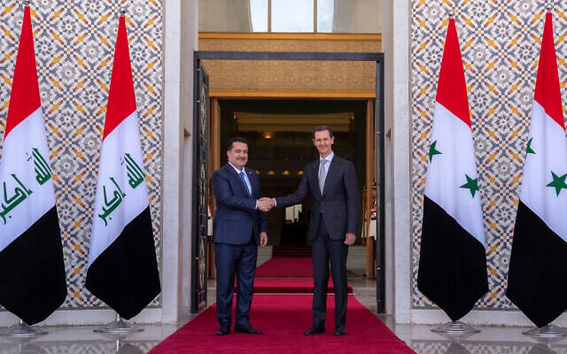 Syrian President Bashar Assad (right) welcomes Iraq's Prime Minister Mohammed Shia al-Sudani during a welcome ceremony in Damascus, Syria, July 16, 2023. (SANA via AP) Syrian President Bashar Assad (right) welcomes Iraq's Prime Minister Mohammed Shia al-Sudani during a welcome ceremony in Damascus, Syria, July 16, 2023. (SANA via AP)