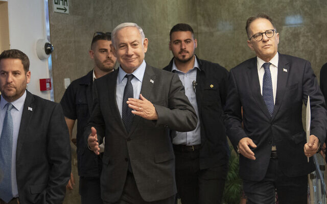 Prime Minister Benjamin Netanyahu, center, arrives to chair a cabinet meeting at his office in Jerusalem, July 17, 2023. (AP Photo/Ohad Zwigenberg, Pool) Prime Minister Benjamin Netanyahu, center, arrives to chair a cabinet meeting at his office in Jerusalem, July 17, 2023. (AP Photo/Ohad Zwigenberg, Pool)