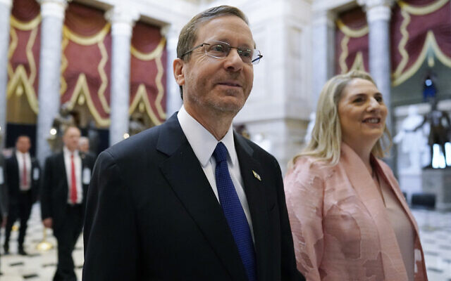 President Isaac Herzog and first lady Michal Herzog walk through Statuary Hall at the Capitol in Washington on their arrival, July 19, 2023. (AP Photo/J. Scott Applewhite)
