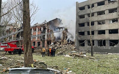 In this photo provided by the National Police of Ukraine, members of emergency services work at a building destroyed by a Russian attack in Mykolaiv, Ukraine, July 20, 2023. (National Police of Ukraine via AP)