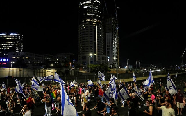 Israelis block the Ayalon Highway during a protest against plans by Prime Minister Benjamin Netanyahu's government to overhaul the judicial system, in Tel Aviv, Israel, Thursday, July 20, 2023. (AP/Ariel Schalit)