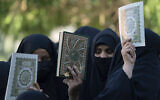 Iraqis raise copies of the Quran, Muslims' holy book, during a protest in Baghdad, Iraq, July 22, 2023. (Hadi Mizban/AP)