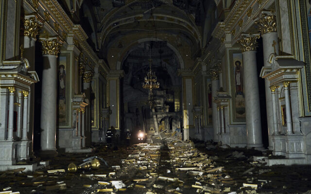 Firefighters walk inside the Odesa Transfiguration Cathedral, heavily damaged in a Russian missile attack in Odesa, Ukraine, July 23, 2023. (Libkos/AP)