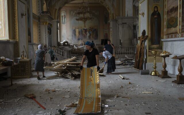 People clean up inside the Odesa Transfiguration Cathedral after it was heavily damaged in Russian missile attacks in Odesa, Ukraine, July 23, 2023. (Jae C. Hong/AP)