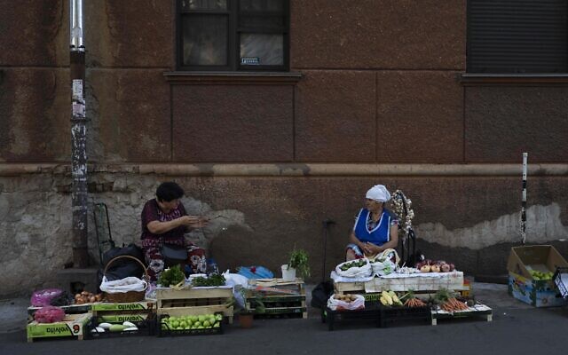 Two street vendors chat in Odesa, Ukraine, July 24, 2023. (Jae C. Hong/AP)