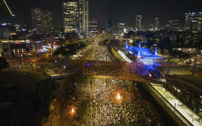 Demonstrators block the traffic on a highway crossing the city during a protest against plans by Netanyahu's government to overhaul the judicial system, in Tel Aviv, July 24, 2023. (AP/Oded Balilty)