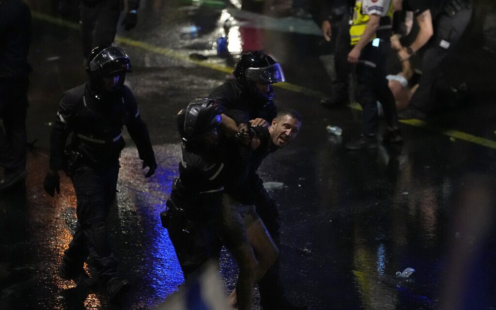 Riot police detain a demonstrator during a protest in Tel Aviv, Monday, July 24, 2023. (AP/Ariel Schalit)