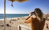 Illustrative: An Israeli lifeguard looks out at the Mediterranean Sea, at Nitzanim Beach, July 17, 2022. (Fitoussi/Flash90)