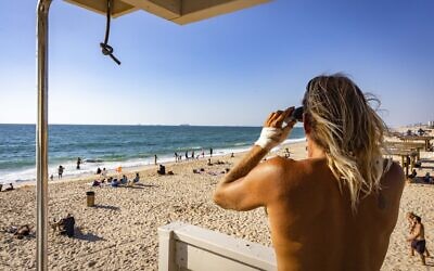 Illustrative: An Israeli lifeguard looks out at the Mediterranean Sea, at Nitzanim Beach, July 17, 2022. (Fitoussi/Flash90)