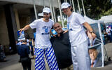 Itzik Zarka (center) with two Likud supporters outside the Likud primaries polling station in Jerusalem, August 10, 2022. (Yonatan Sindel/Flash90)