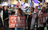 File: A doctor holds a sign saying 'The doctors are fighting for the life of democracy,' at a rally against the government's judicial overhaul bills in Tel Aviv on February 25, 2023. (Gili Yaari/Flash90)