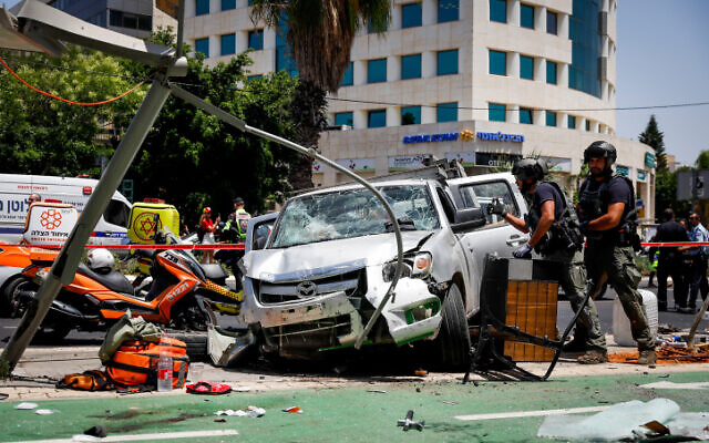 Police and rescue forces at the scene of a car ramming and stabbing terror attack in north Tel Aviv on June 4, 2023. (Miriam Alster/Flash90)