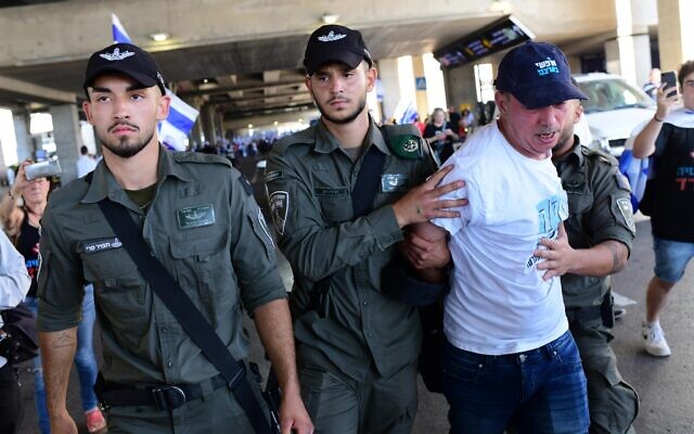 Israelis protest and clash with police during a protest against the Israeli government's planned judicial overhaul, at the Ben Gurion Airport near Tel Aviv, July 3, 2023. (Tomer Neuberg/Flash90) Israelis protest and clash with police during a protest against the Israeli government's planned judicial overhaul, at the Ben Gurion Airport near Tel Aviv, July 3, 2023. (Tomer Neuberg/Flash90)
