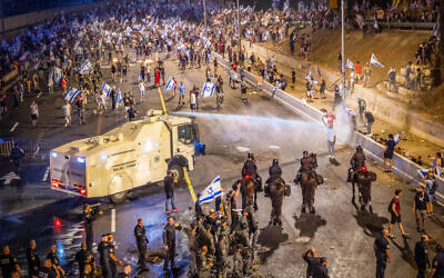 Israelis block the Ayalon Highway during a protest against the Israeli government's planned judicial overhaul and in response to the removal of Tel Aviv District Commander Amichai Eshed in Tel Aviv, July 5, 2023. (Yossi Aloni/Flash90)