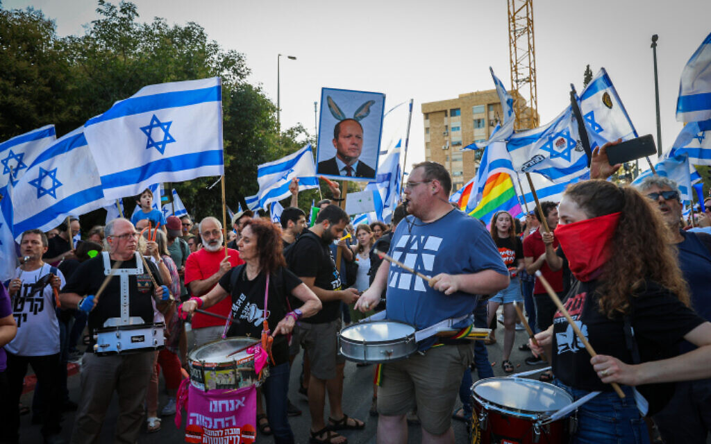 Israelis protest against the government's planned judicial overhaul outside the house of Economy Minister Nir Barkat, in Jerusalem, July 6, 2023. (Noam Revkin Fenton/Flash90)