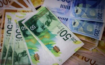 Illustration of Israeli currency, July 9, 2023. (Chaim Goldberg/Flash90)