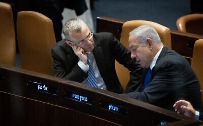 Prime Minister Benjamin Netanyahu speaks with Minister of Justice Yariv Levin during a Knesset plenum hearing, July 10, 2023. (Yonatan Sindel/Flash90)