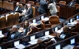Yesh Atid MKs wear black t-shirts adorned with Israeli flags during plenum deliberations on the 'reasonableness' bill, at the Knesset, July 10, 2023. (Yonatan Sindel/Flash90)