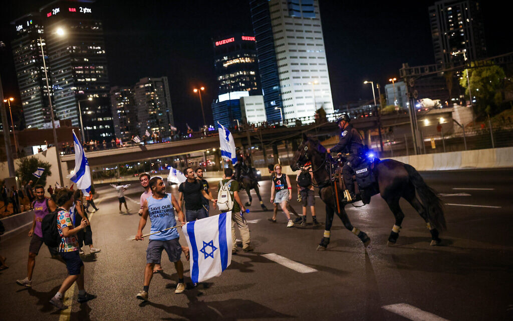 Anti-judicial overhaul demonstrators block the Ayalon Highway in Tel Aviv on July 11, 2023. (Chaim Goldberg/Flash90)