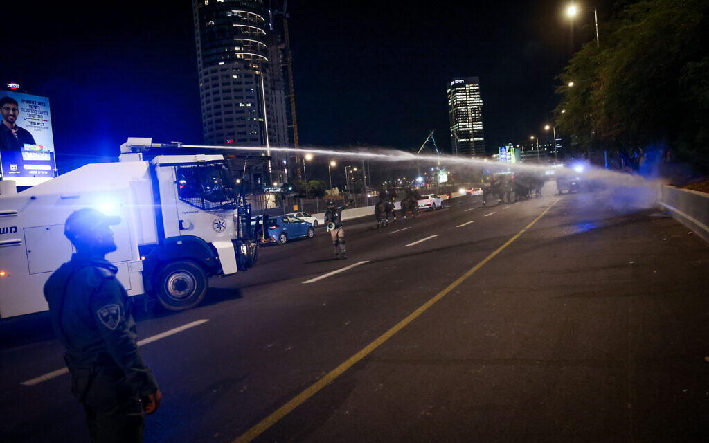 Police use a water cannon against anti-judicial overhaul demonstrators in Tel Aviv on July 11, 2023.  (Chaim Goldberg/Flash90)