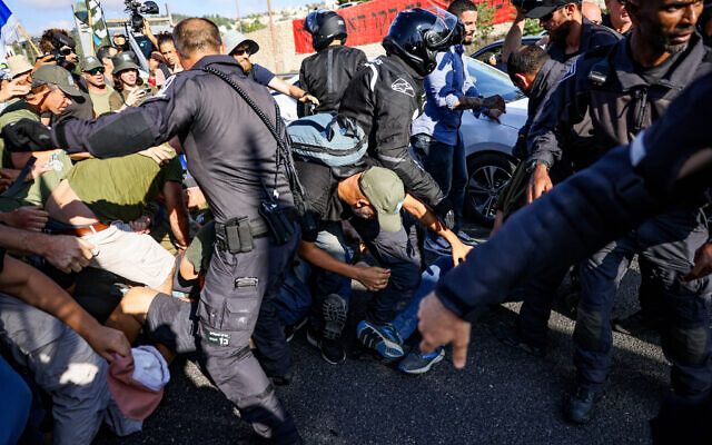 Demonstrators block a road and clash with police during a protest against the judicial overhaul on Route 1, near Ein Hemed, July 11, 2023. (Chaim Goldberg/Flash90) Demonstrators block a road and clash with police during a protest against the judicial overhaul on Route 1, near Ein Hemed, July 11, 2023. (Chaim Goldberg/Flash90)