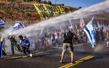 Anti-judicial overhaul demonstrators block Route 1 and clash with police during a protest near Ein Hemed, July 11, 2023. (Photo by Chaim Goldberg/Flash90)