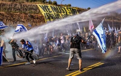 Anti-judicial overhaul demonstrators block Route 1 and clash with police during a protest near Ein Hemed, July 11, 2023. (Photo by Chaim Goldberg/Flash90)