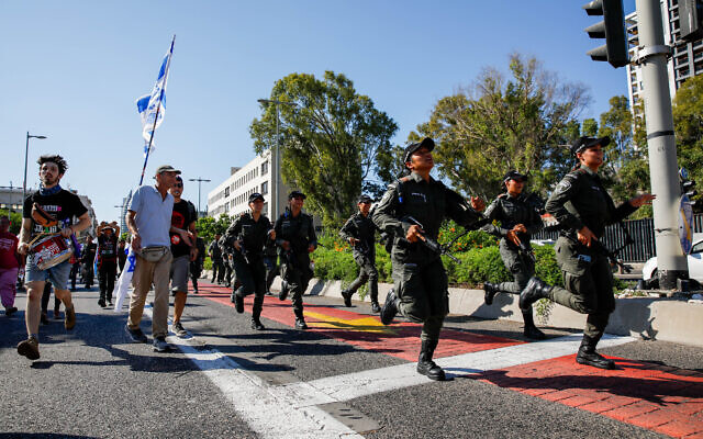 Police and anti-overhaul demonstrators in Haifa on July 11, 2023. (Shir Torem/Flash90) Police and anti-overhaul demonstrators in Haifa on July 11, 2023. (Shir Torem/Flash90)