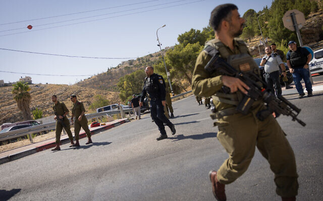 Israeli security forces at the scene of a terror shooting, near the West Bank settlement of Tekoa, July 16, 2023. (Chaim Goldberg/Flash90) Israeli security forces at the scene of a terror shooting, near the West Bank settlement of Tekoa, July 16, 2023. (Chaim Goldberg/Flash90)