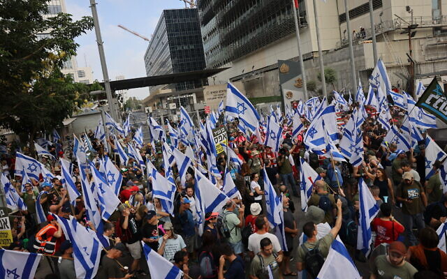Protesters against the judicial overhaul block an entrance to the Defense Ministry in Tel Aviv, July 18, 2023 (Chaim Goldberg/Flash90)