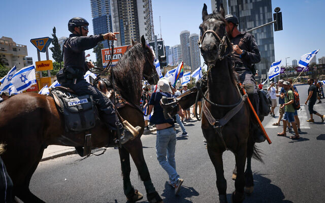 Police clear protesters from the road during a protest against the government's judicial overhaul plans in Ramat Gan, July 18, 2023. (Chaim Goldberg/Flash90) Police clear protesters from the road during a protest against the government's judicial overhaul plans in Ramat Gan, July 18, 2023. (Chaim Goldberg/Flash90)
