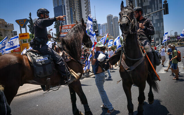 Mounted police officer apparently kicks a protester during a demonstration against the government's judicial overhaul plans in Ramat Gan, July 18, 2023. (Chaim Goldberg/Flash90)
