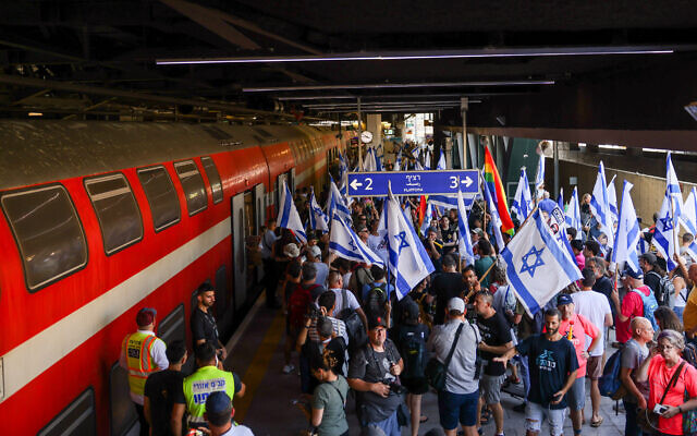 Protesters against the government's judicial overhaul rally at Tel Aviv's Hashalom train station, July 18, 2023. (Chaim Goldberg/Flash90) Protesters against the government's judicial overhaul rally at Tel Aviv's Hashalom train station, July 18, 2023. (Chaim Goldberg/Flash90)