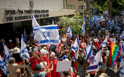 Israelis protest the government's judicial overhaul outside the Rabbinical Court of Tel Aviv, July 18, 2023. (Miriam Alster/Flash90)