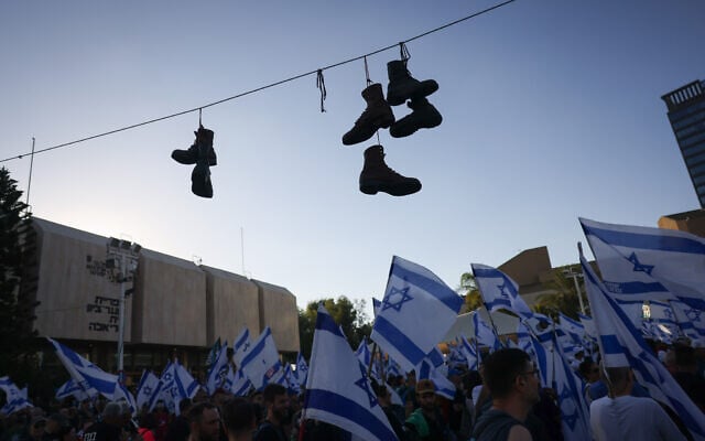 Israeli military reservists line up to sign a declaration of refusal to report for duty to protest against plans by Prime Minister Benjamin Netanyahu's government to overhaul the judicial system, in Tel Aviv, Israel, July 19, 2023. (Chaim Goldberg/Flash90)