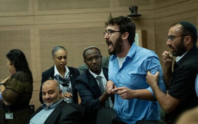 A parliamentary adviser shouts at Knesset Constitution, Law and Justice Committee Chairman MK Simcha Rothman during a hearing to approve the coalition's bill to drastically reduce the courts' use of the reasonableness standard, July 19, 2023. (Yonatan Sindel/Flash90)