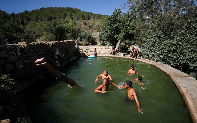 People enjoy a hot summer afternoon at the Ein Lavan Spring in Jerusalem, on July 23, 2023. (Jamal Awad/Flash90) People enjoy a hot summer afternoon at the Ein Lavan Spring in Jerusalem, on July 23, 2023. (Jamal Awad/Flash90)