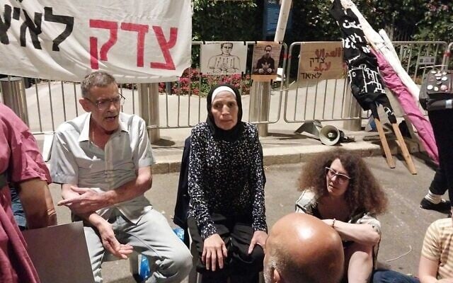The parents of Iyad Halak, an autistic Palestinian man killed in a police shooting in Jerusalem's Old City, at the protest against the judicial overhaul outside the President's Residence in Jerusalem, July 9, 2023. (Iddo Schejter/Times of Israel) The parents of Iyad Halak, an autistic Palestinian man killed in a police shooting in Jerusalem's Old City, at the protest against the judicial overhaul outside the President's Residence in Jerusalem, July 9, 2023. (Iddo Schejter/Times of Israel)