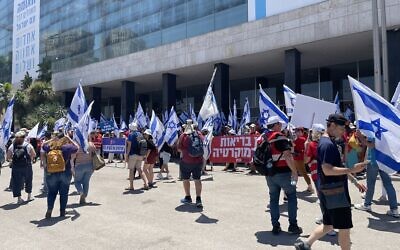 Doctors arrive at Jerusalem's International Convention Center for a rally protesting the government's judicial overhaul legislation. July 23, 2023. (Renee Ghert-Zand/Times of Israel)