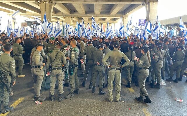 Police and anti-overhaul protesters at Ben Gurion Airport on July 11, 2023. (Carrie Keller-Lynn/Times of Israel)
