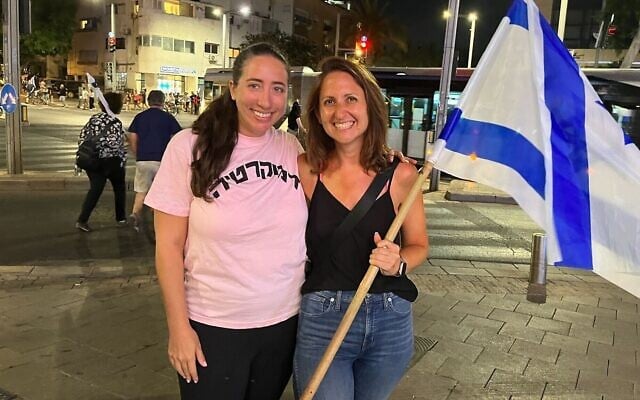 Janessa Goldberg (L) and Elana Resnick at an anti-overhaul protest on Tel Aviv's Kaplan Street, July 11, 2023. (Naomi Lanzkron/Times of Israel)
